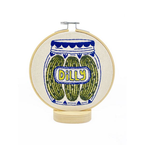 Embroidery hoop with a design of pickles in a jar labeled 'Dilly' on a white background | Pickles DIY Embroidery Kit | Hook, Line & Tinker | boogie + birdie