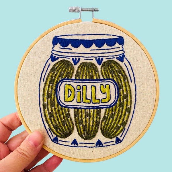 Embroidery hoop with a design of pickles in a jar labeled 'Dilly' on a white background | Pickles DIY Embroidery Kit | Hook, Line & Tinker | boogie + birdie